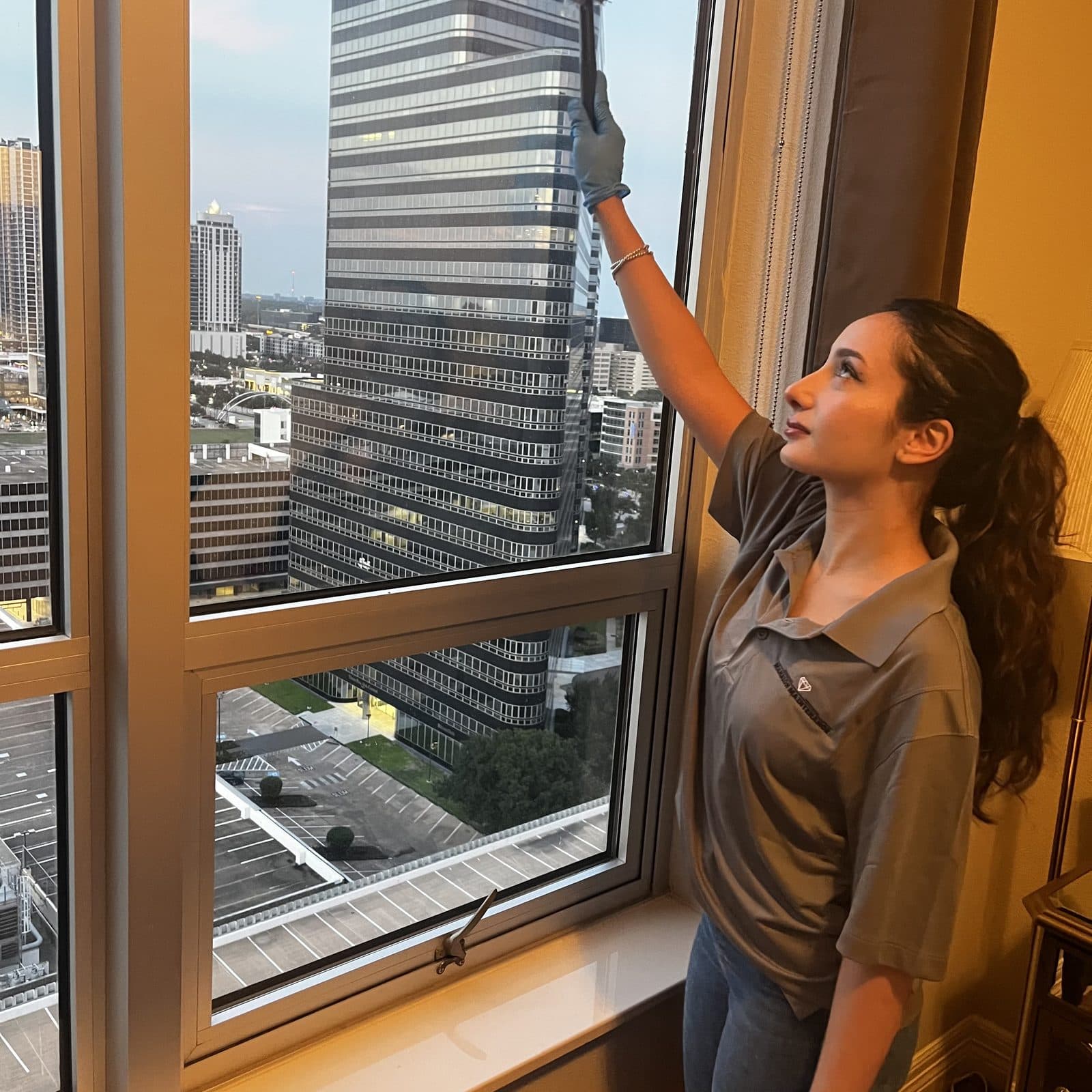 High-rise window cleaning with downtown Houston visible outside