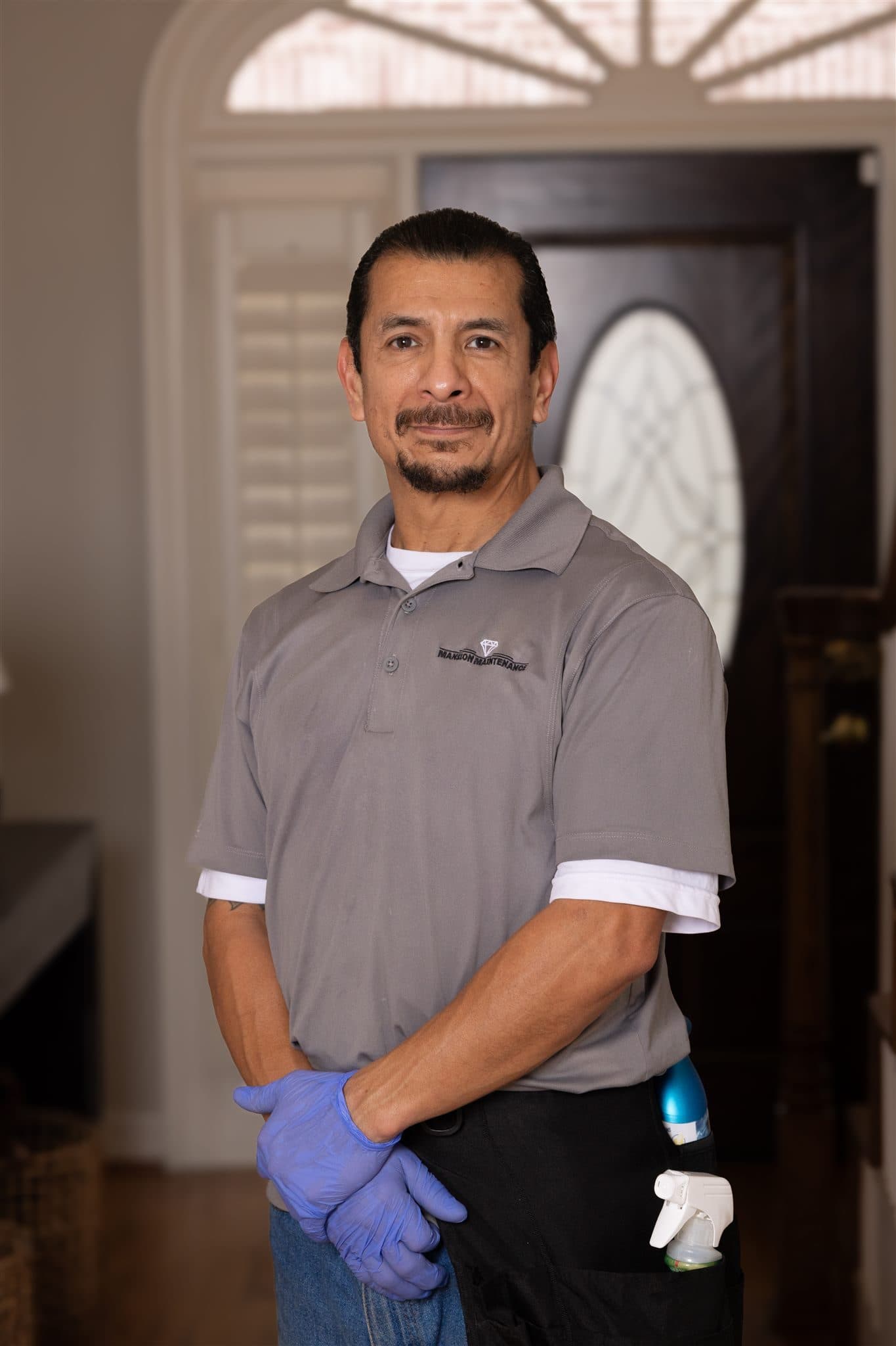Mansion crew member standing near an entryway
