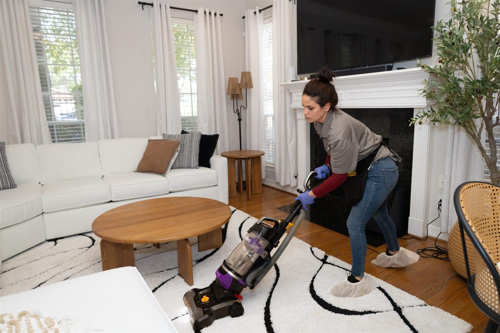 Cleaner vacuuming an area rug